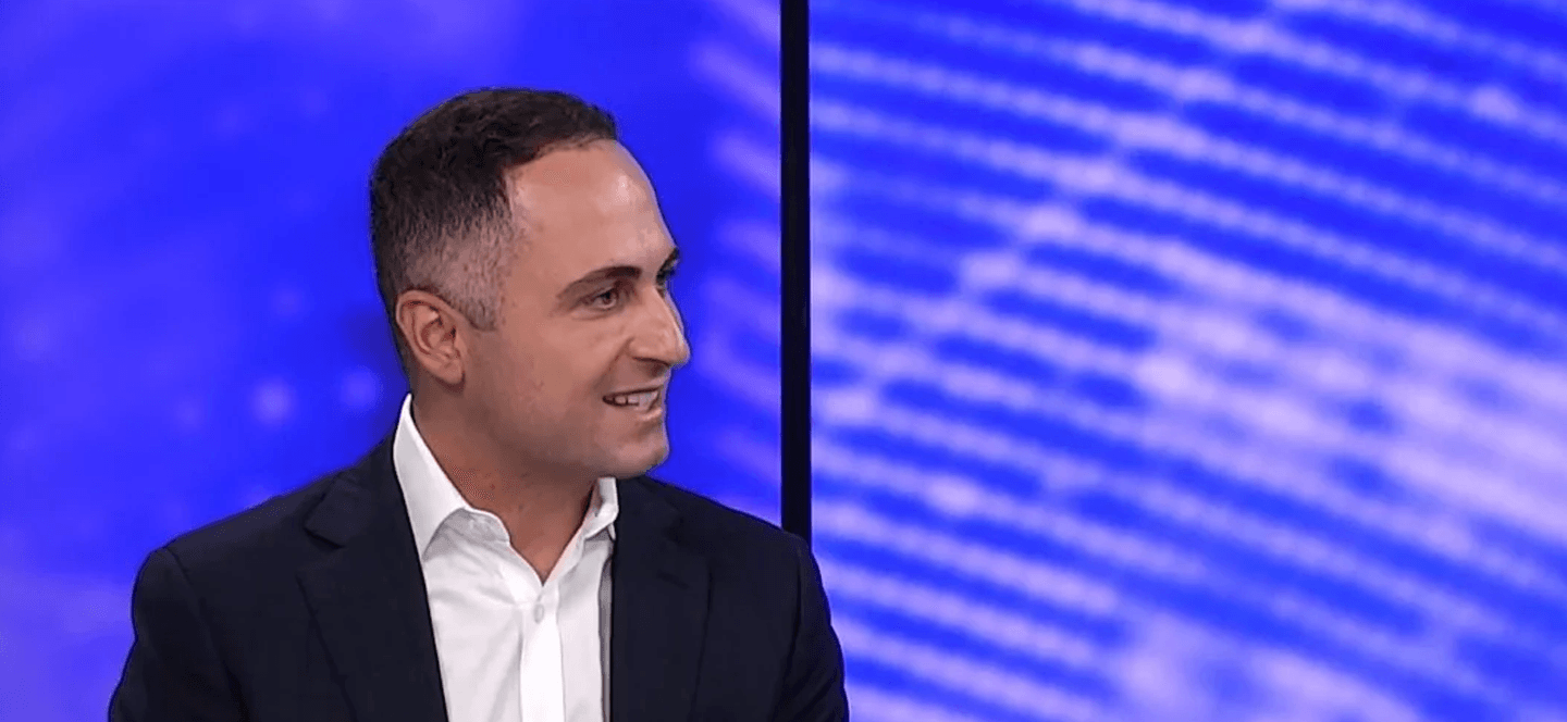 Frank Danieli in front of a blue and pink screen