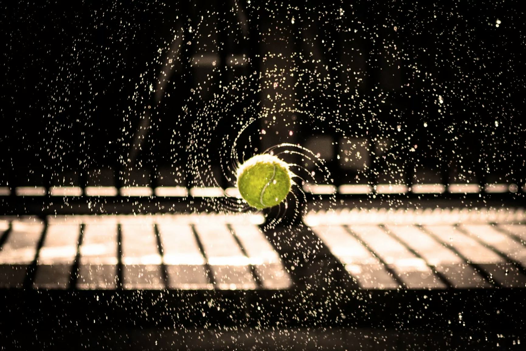 Wet tennis ball spinning in the air