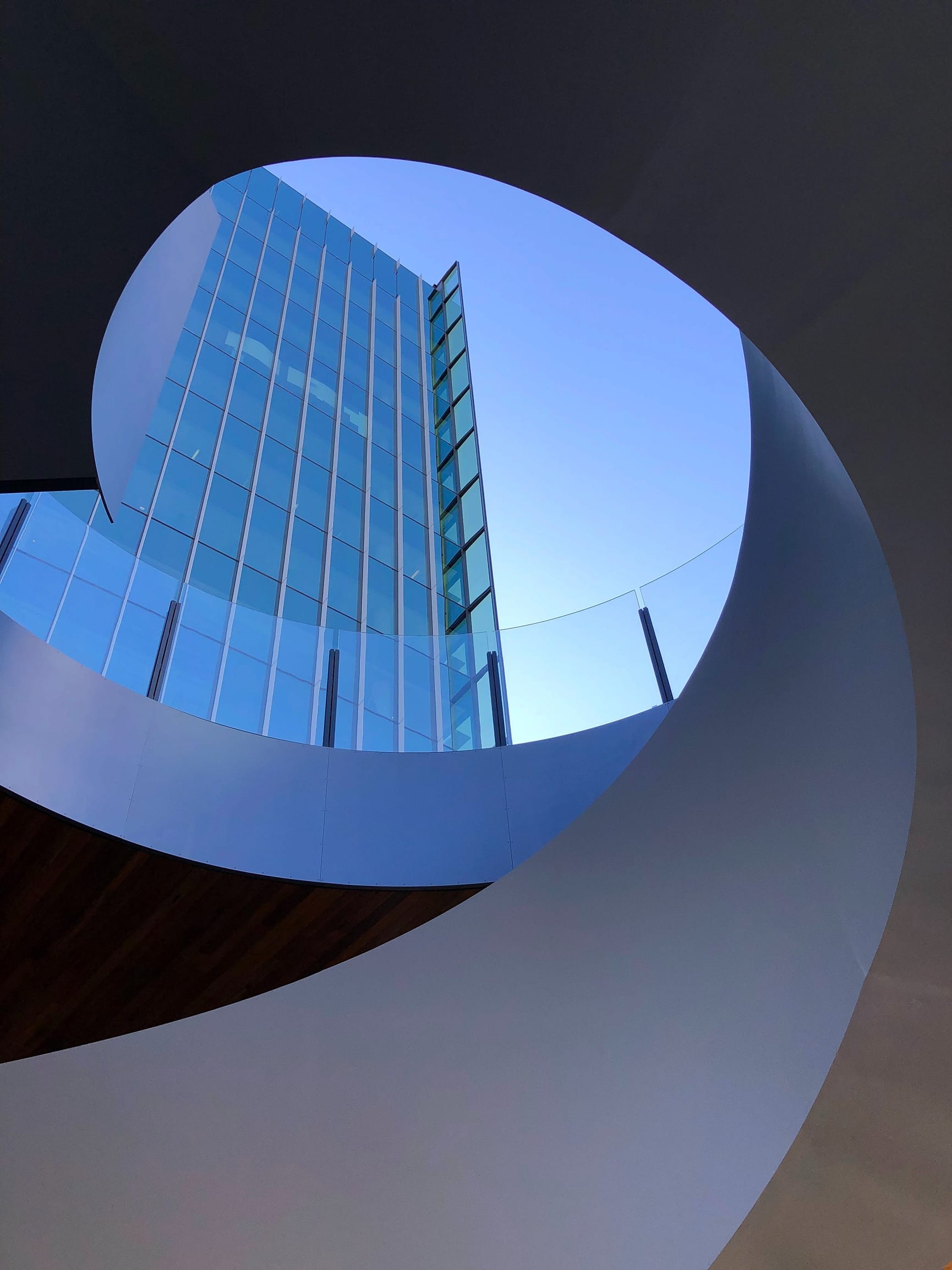 Looking up at buildings through an architecturally designed spiral roof